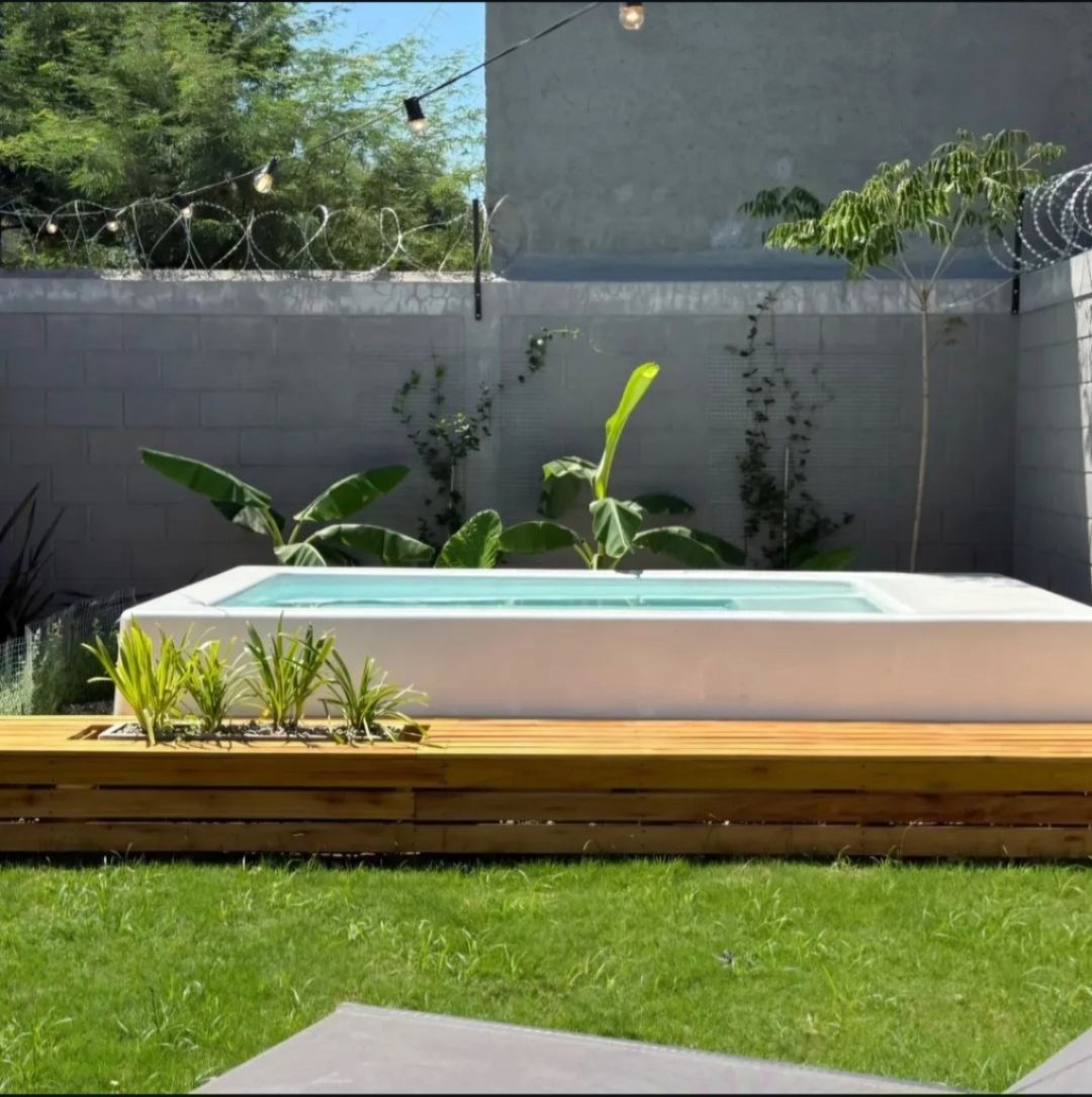 Mini piscina elevada instalada sobre un deck de madera